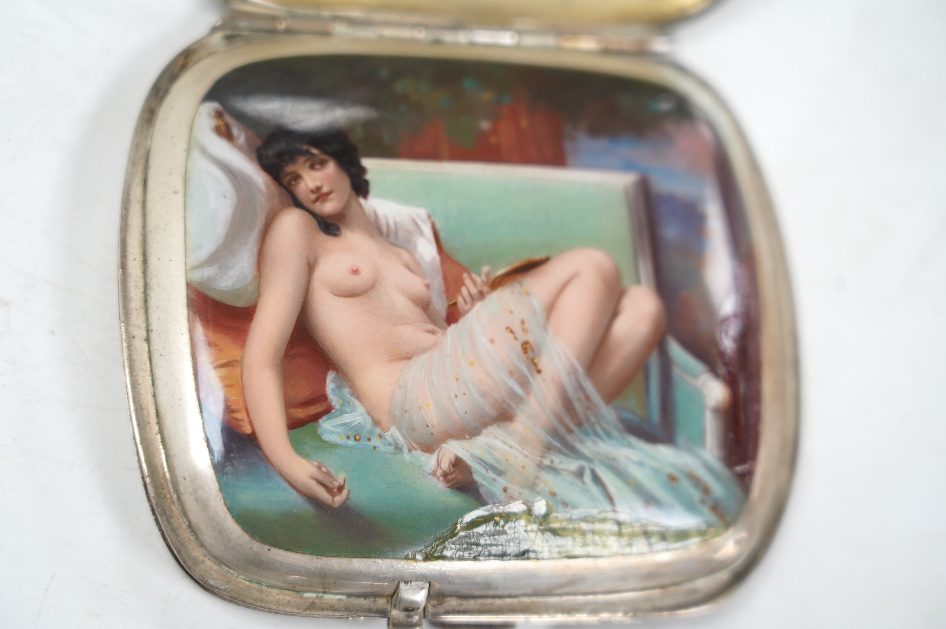 A 1920's/1930's German? 935 standard white metal cigarette case, with interior cover enamelled with a reclining nude (enamelled damaged and restored), 91mm, gross weight 6.1oz. Condition - poor
